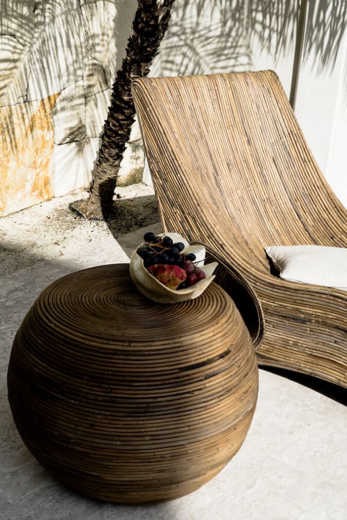 Multifunctional brown round rattan table for use as a coffee table, side table, or decorative piece