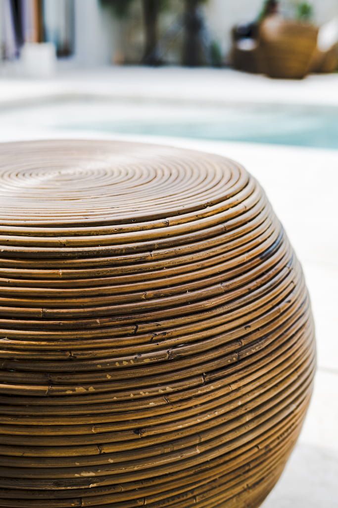 Multifunctional brown round rattan table for use as a coffee table, side table, or decorative piece