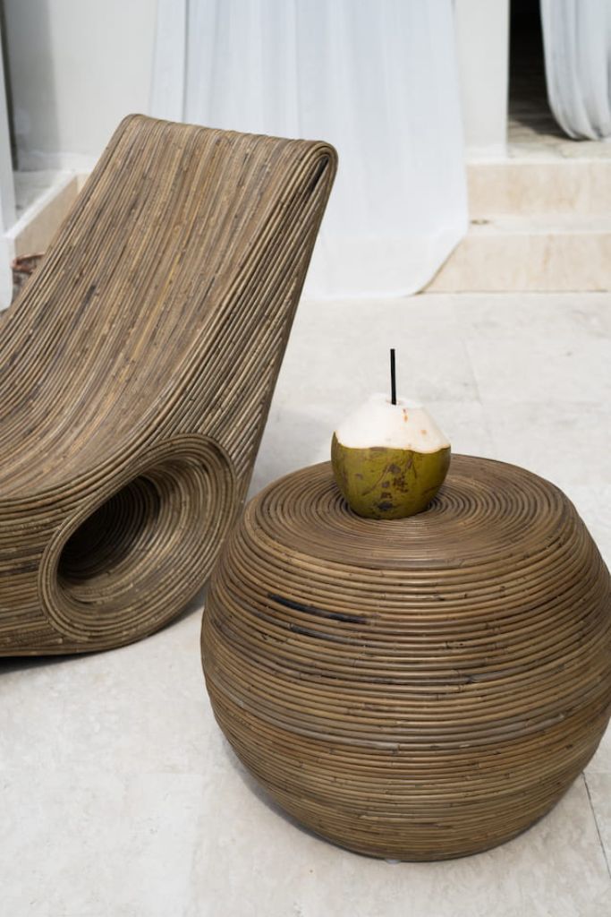 Multifunctional brown round rattan table for use as a coffee table, side table, or decorative piece