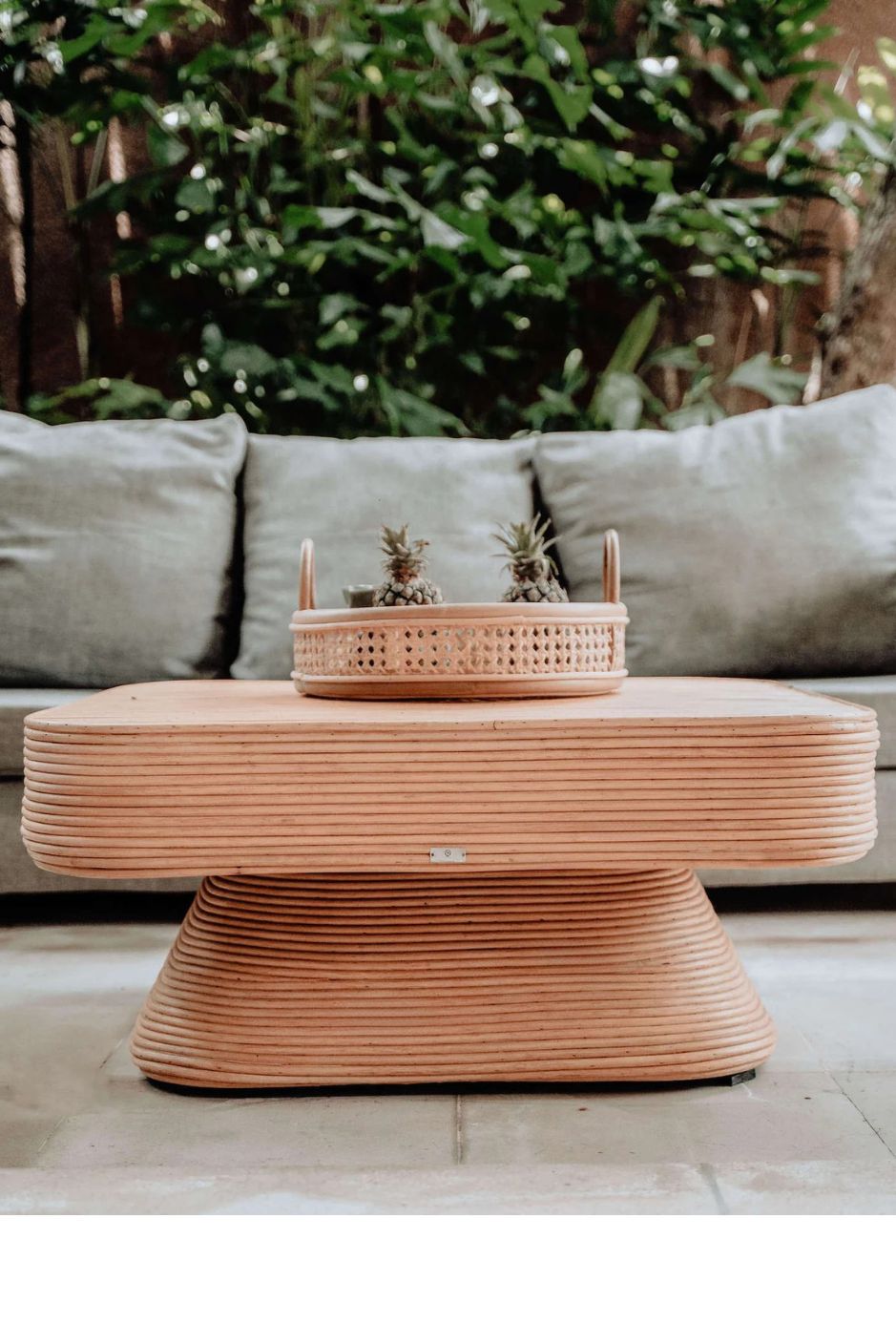 Coastal style natural rattan table Tegal Carla Square with tilted pedestal, handmade artisan furniture for living room, swimming pool or lounge spaces.
