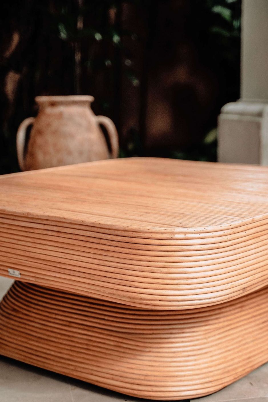 Coastal style natural rattan table Tegal Carla Square with tilted pedestal, handmade artisan furniture for living room, swimming pool or lounge spaces.