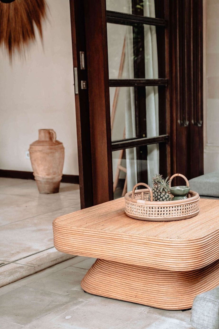 Coastal style natural rattan table Tegal Carla Square with tilted pedestal, handmade artisan furniture for living room, swimming pool or lounge spaces.