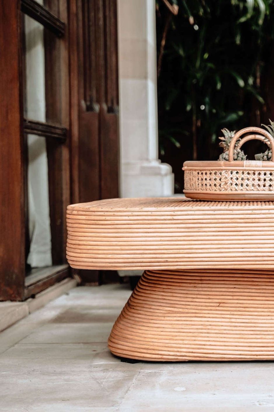 Coastal style natural rattan table Tegal Carla Square with tilted pedestal, handmade artisan furniture for living room, swimming pool or lounge spaces.