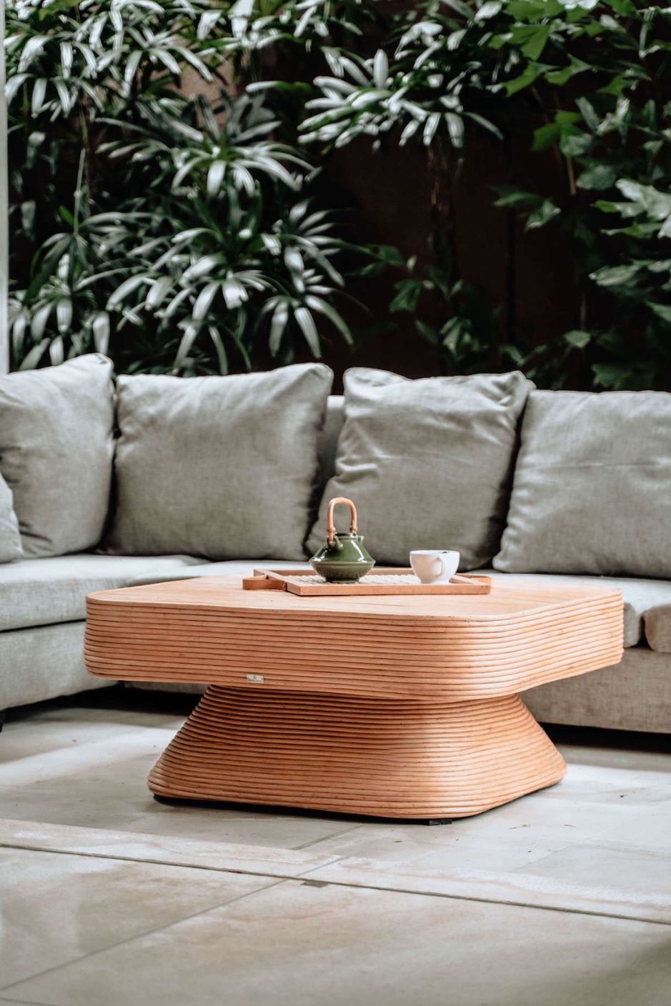 Coastal style natural rattan table Tegal Carla Square with tilted pedestal, handmade artisan furniture for living room, swimming pool or lounge spaces.