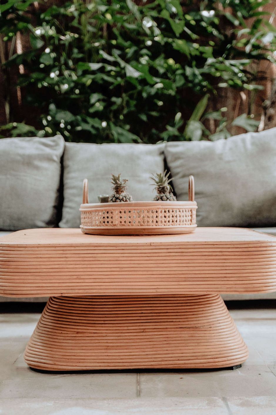 Coastal style natural rattan table Tegal Carla Square with tilted pedestal, handmade artisan furniture for living room, swimming pool or lounge spaces.