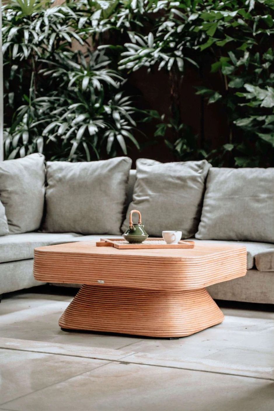 Coastal style natural rattan table Tegal Carla Square with tilted pedestal, handmade artisan furniture for living room, swimming pool or lounge spaces.
