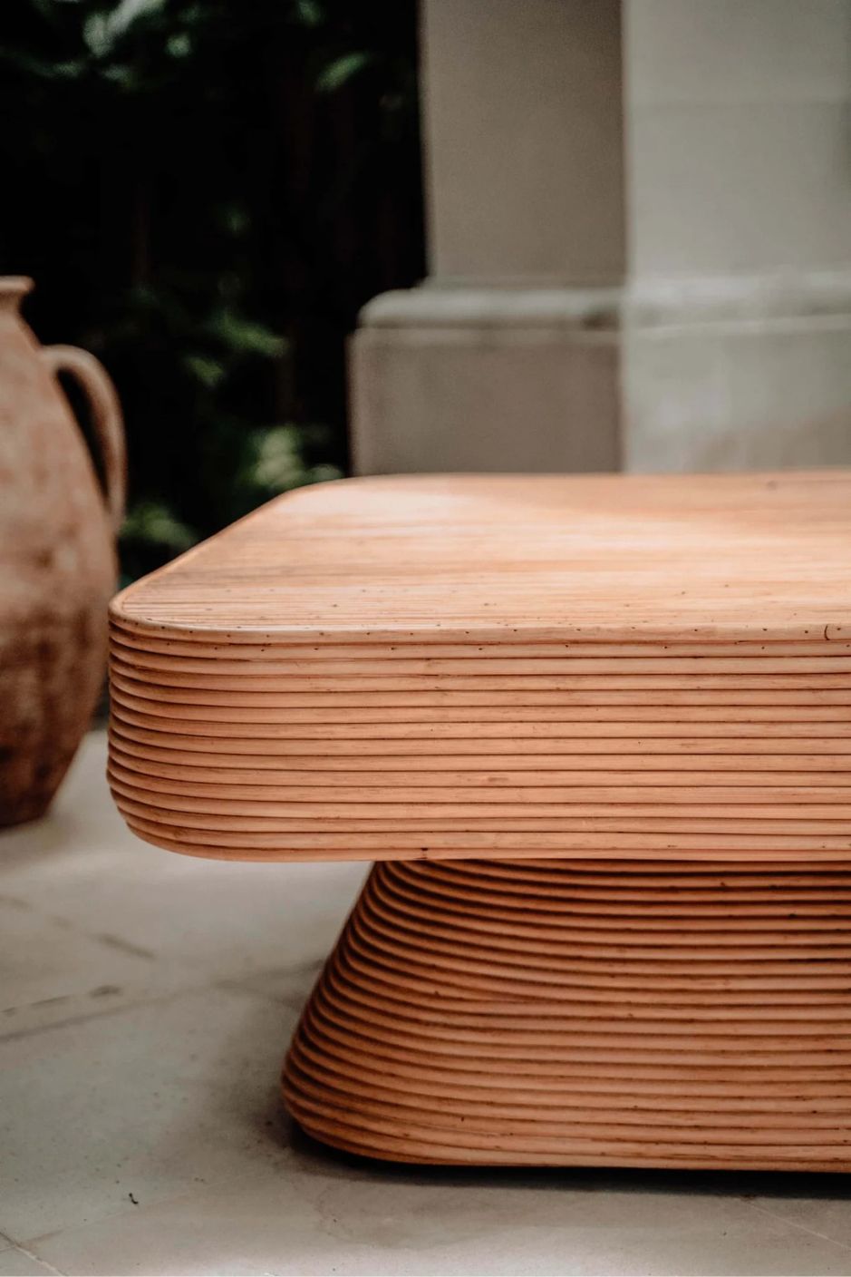 Coastal style natural rattan table Tegal Carla Square with tilted pedestal, handmade artisan furniture for living room, swimming pool or lounge spaces.
