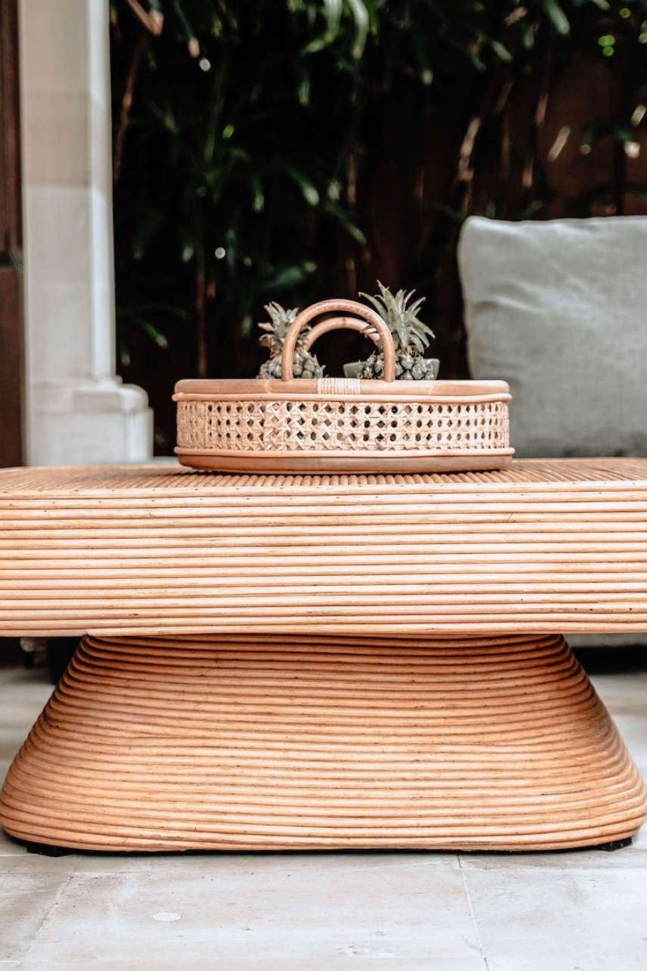 Coastal style natural rattan table Tegal Carla Square with tilted pedestal, handmade artisan furniture for living room, swimming pool or lounge spaces.