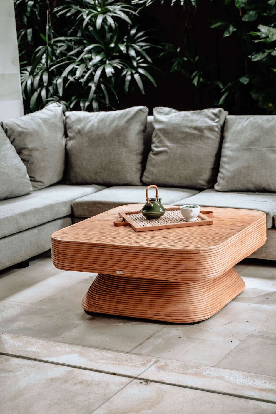 Coastal style natural rattan table Tegal Carla Square with tilted pedestal, handmade artisan furniture for living room, swimming pool or lounge spaces.