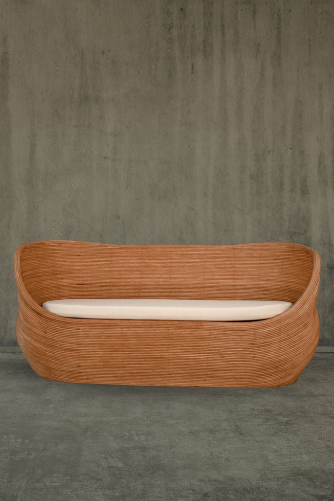 Handmade cognac round rattan sofa Tegal with ecru cushions, designed for eco-friendly outdoor living on patios and terraces