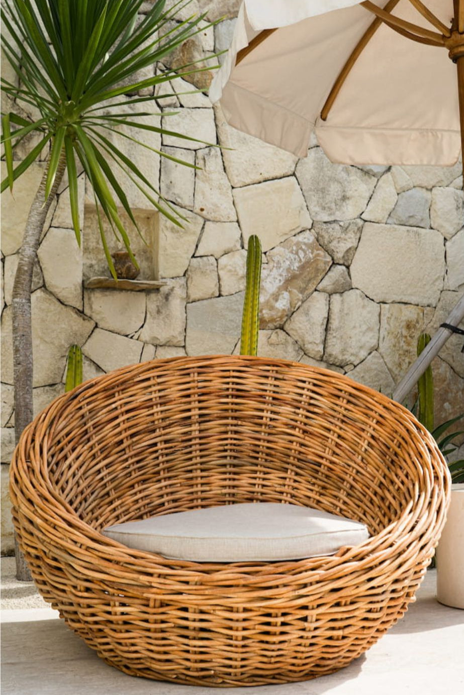 Ingka Halo cognac handmade rattan sofa lounge chair with thick weave, modern minimalist design for living rooms and lounges.