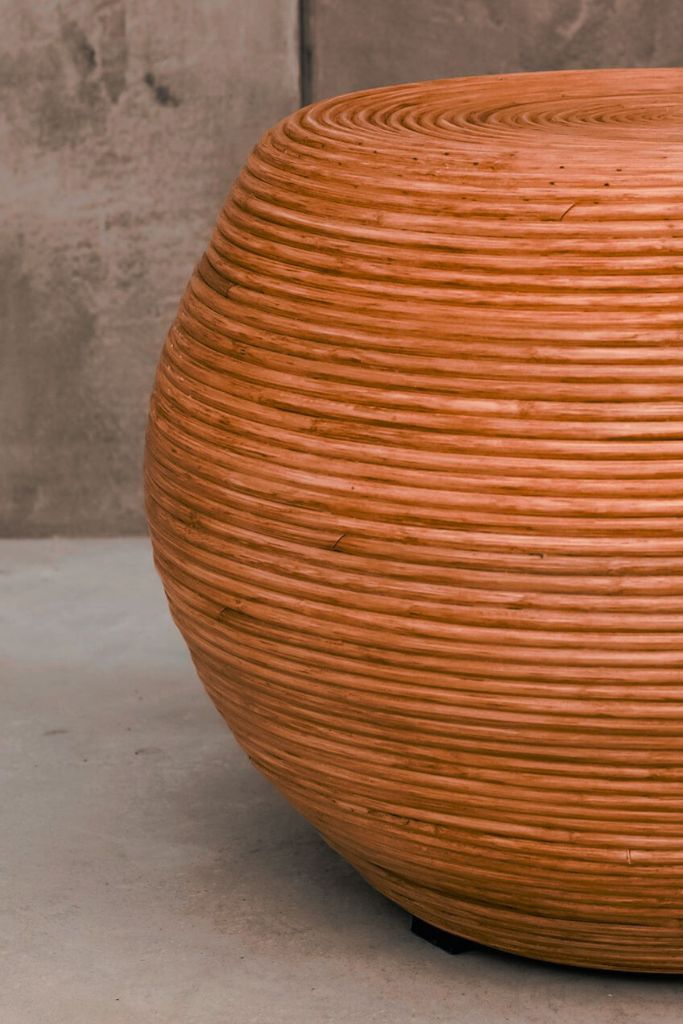 Multifunctional cognac round rattan table for use as a coffee table, side table, or decorative piece