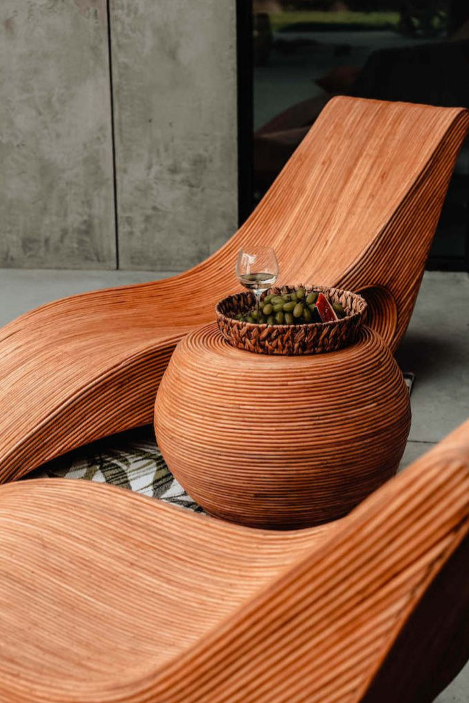 Multifunctional cognac round rattan table for use as a coffee table, side table, or decorative piece