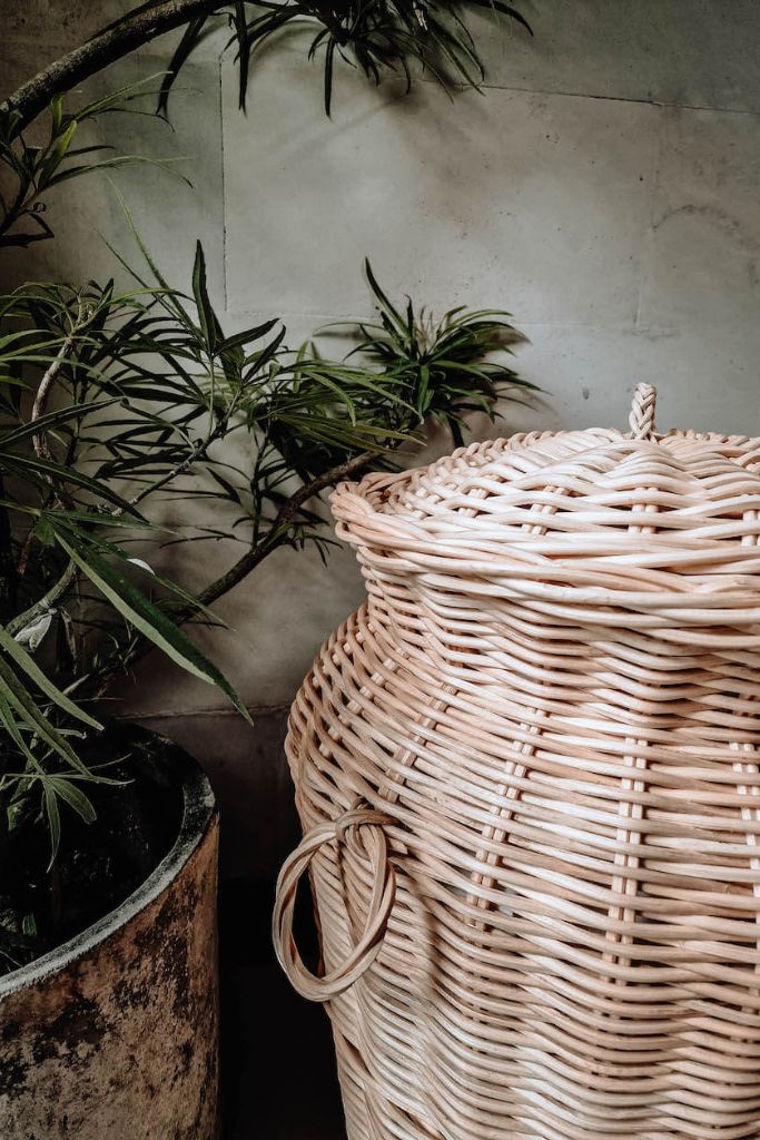Handwoven Loomi Basket made from natural rattan, eco-friendly storage solution for bedrooms, bathrooms, living rooms, and laundry rooms, lightweight and durable, rustic and stylish home organisation accessory.