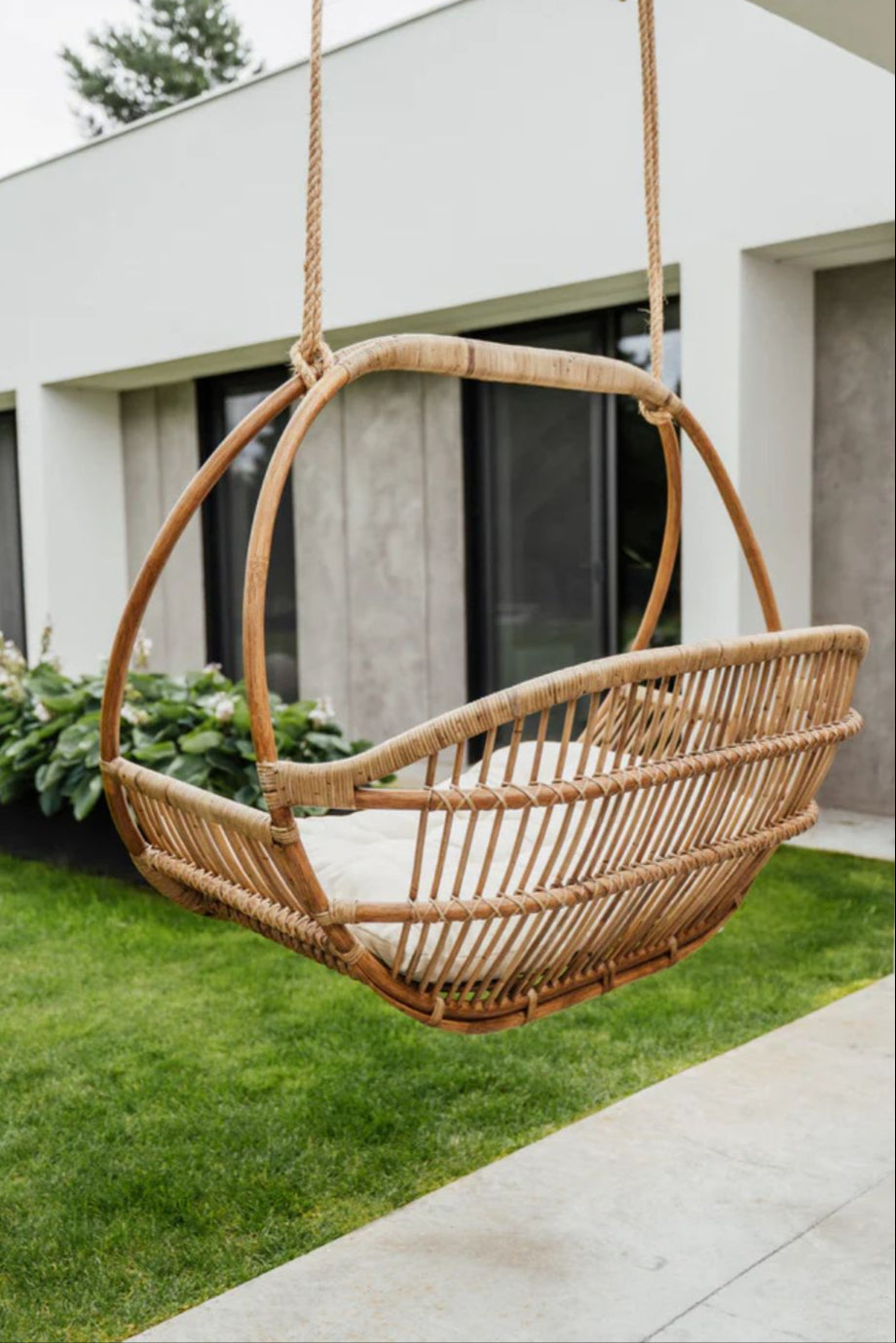 Henry single or double handmade durable light rattan hanging chair for indoor living rooms, covered terraces, patios, balconies, and outdoor gardens