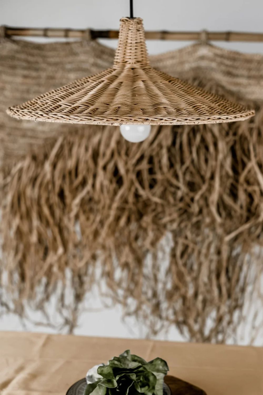 Handmade Sutter lamp in natural rattan with bohemian tropical design, perfect for stylish home décor