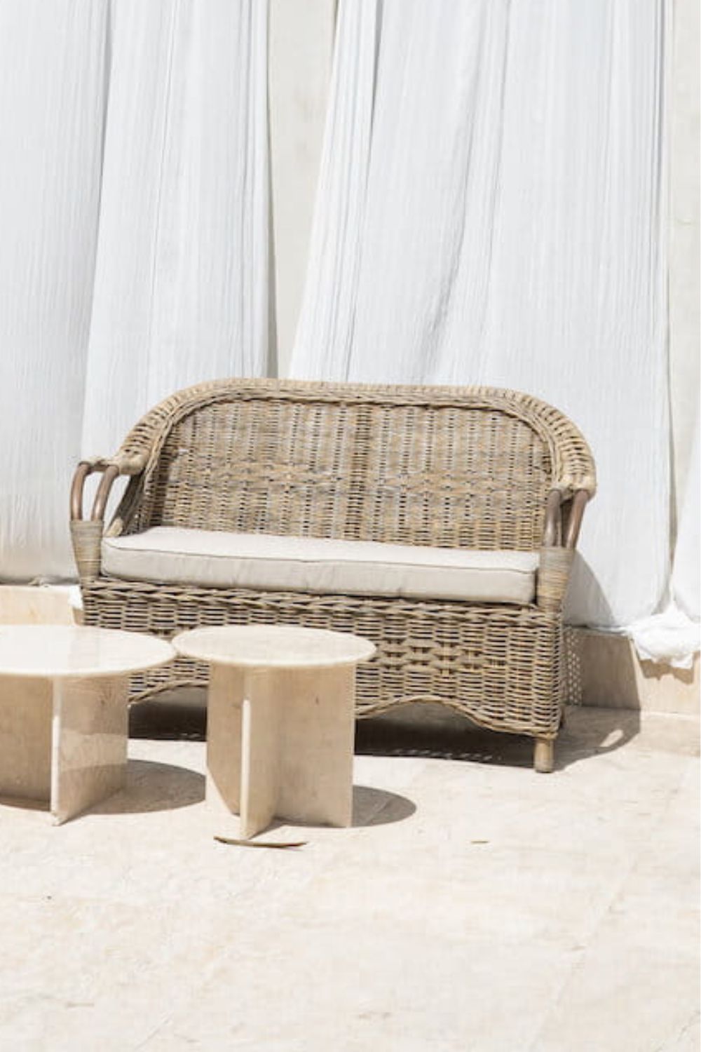 Tyo two-seater light brown rattan sofa with curved armrests