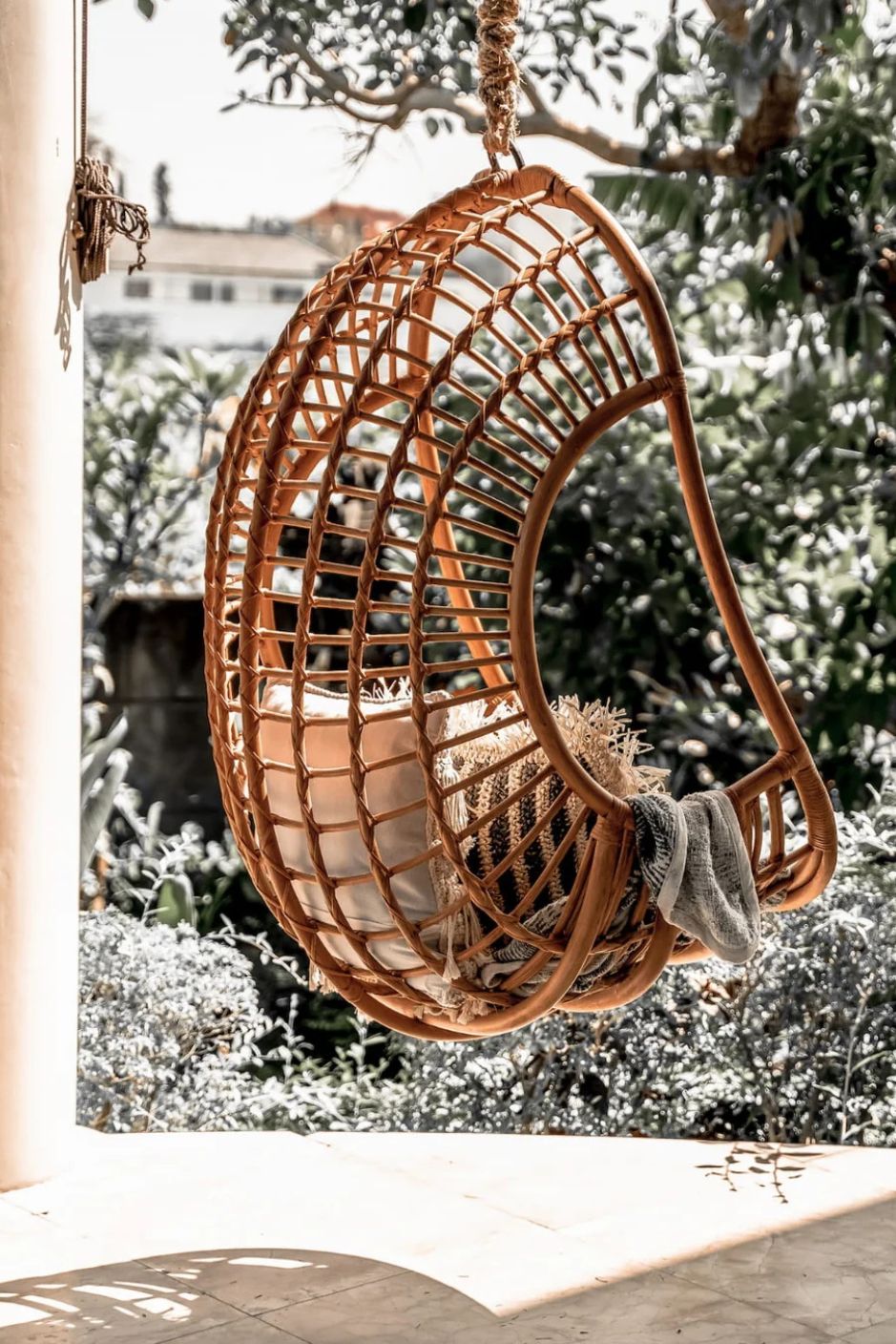 Hugo Rattan Hanging Chair in natural, cognac and brown rattan, handmade, eco-friendly, zero plastic, boho style, perfect for living room, terrace, or patio, stylish and comfortable swinging chair for modern or island-inspired interiors.