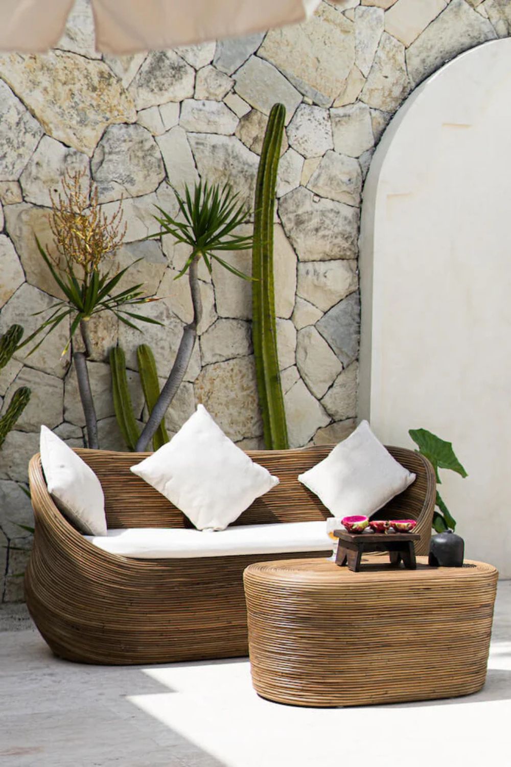 Handmade brown round rattan sofa Tegal with ecru cushions, designed for eco-friendly outdoor living on patios and terraces