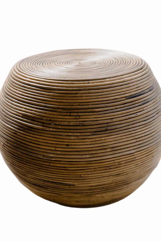 Multifunctional brown round rattan table for use as a coffee table, side table, or decorative piece