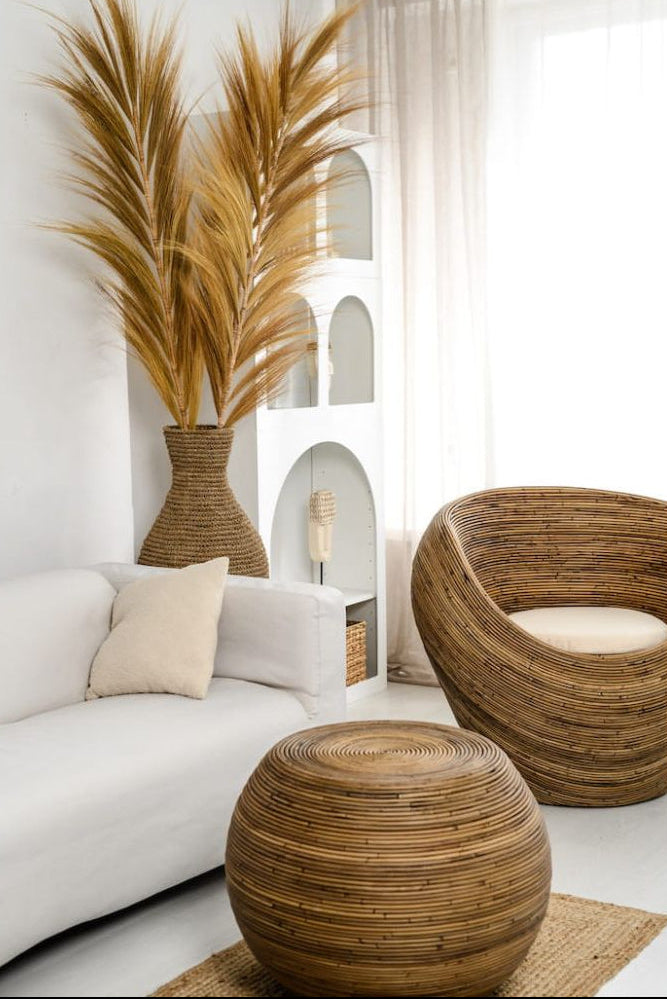 Multifunctional brown round rattan table for use as a coffee table, side table, or decorative piece