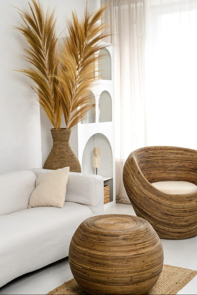 Multifunctional brown round rattan table for use as a coffee table, side table, or decorative piece