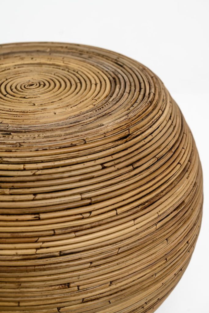 Multifunctional brown round rattan table for use as a coffee table, side table, or decorative piece