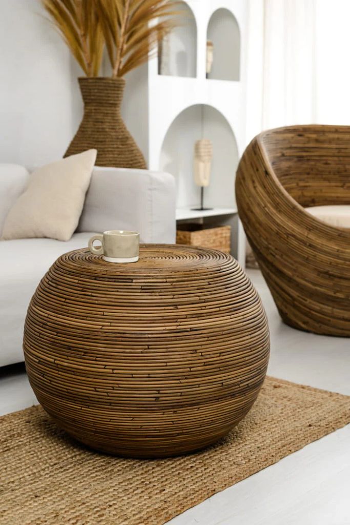 Multifunctional brown round rattan table for use as a coffee table, side table, or decorative piece