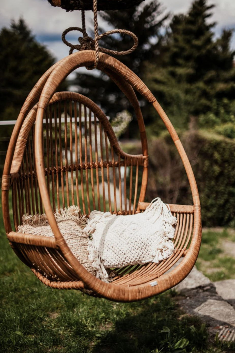 Henry single or double handmade durable cognac rattan hanging chair for indoor living rooms, covered terraces, patios, balconies, and outdoor gardens