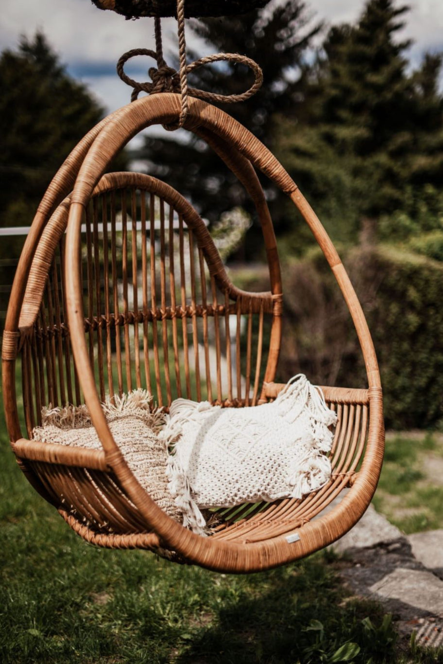 Henry single or double handmade durable cognac rattan hanging chair for indoor living rooms, covered terraces, patios, balconies, and outdoor gardens