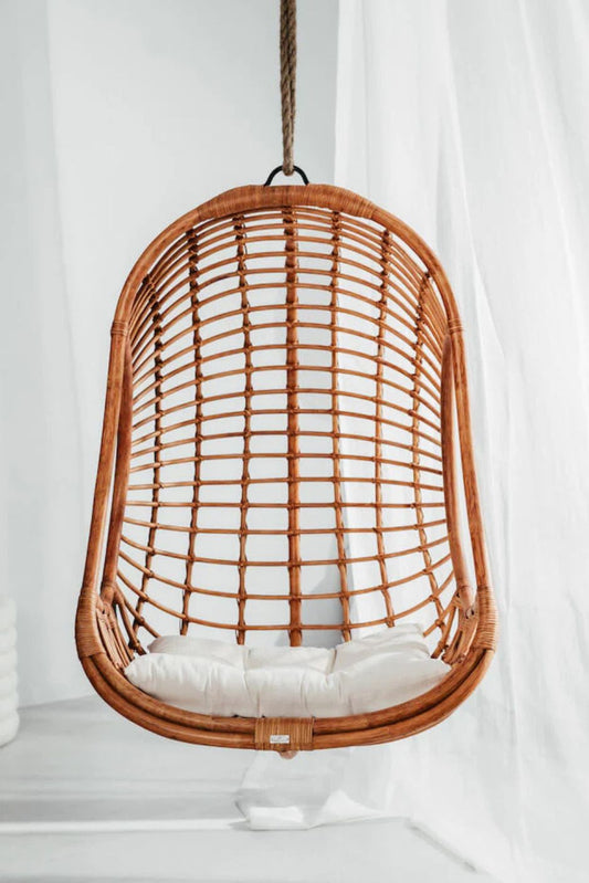 Hugo Rattan Hanging Chair in natural, cognac and brown rattan, handmade, eco-friendly, zero plastic, boho style, perfect for living room, terrace, or patio, stylish and comfortable swinging chair for modern or island-inspired interiors.