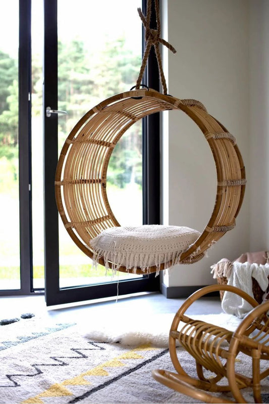Durable handmade natural rattan hanging swing chair junior, designed for relaxing indoor or outdoor comfort.