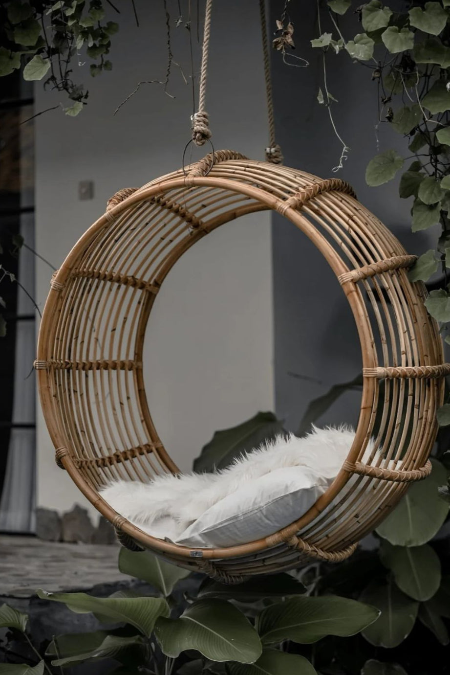 Durable handmade natural rattan hanging swing chair single, designed for relaxing indoor or outdoor comfort.