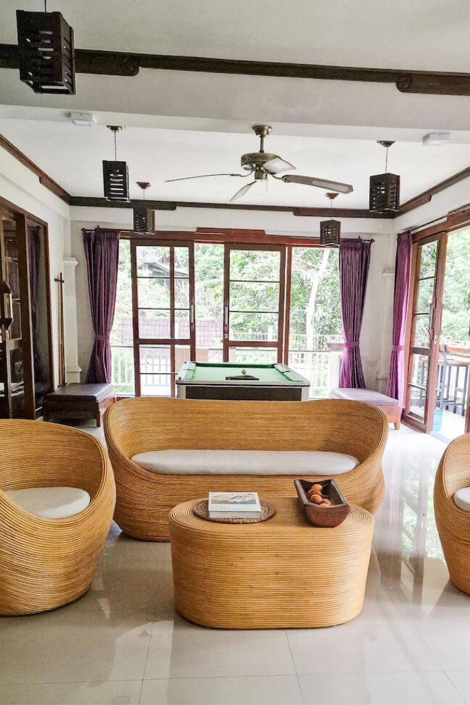 Handmade natural round rattan sofa Tegal with ecru cushions, designed for eco-friendly outdoor living on patios and terraces