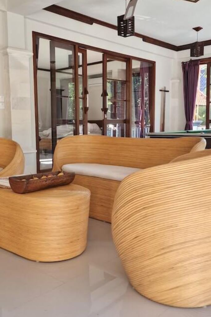 Handmade natural round rattan sofa Tegal with ecru cushions, designed for eco-friendly outdoor living on patios and terraces