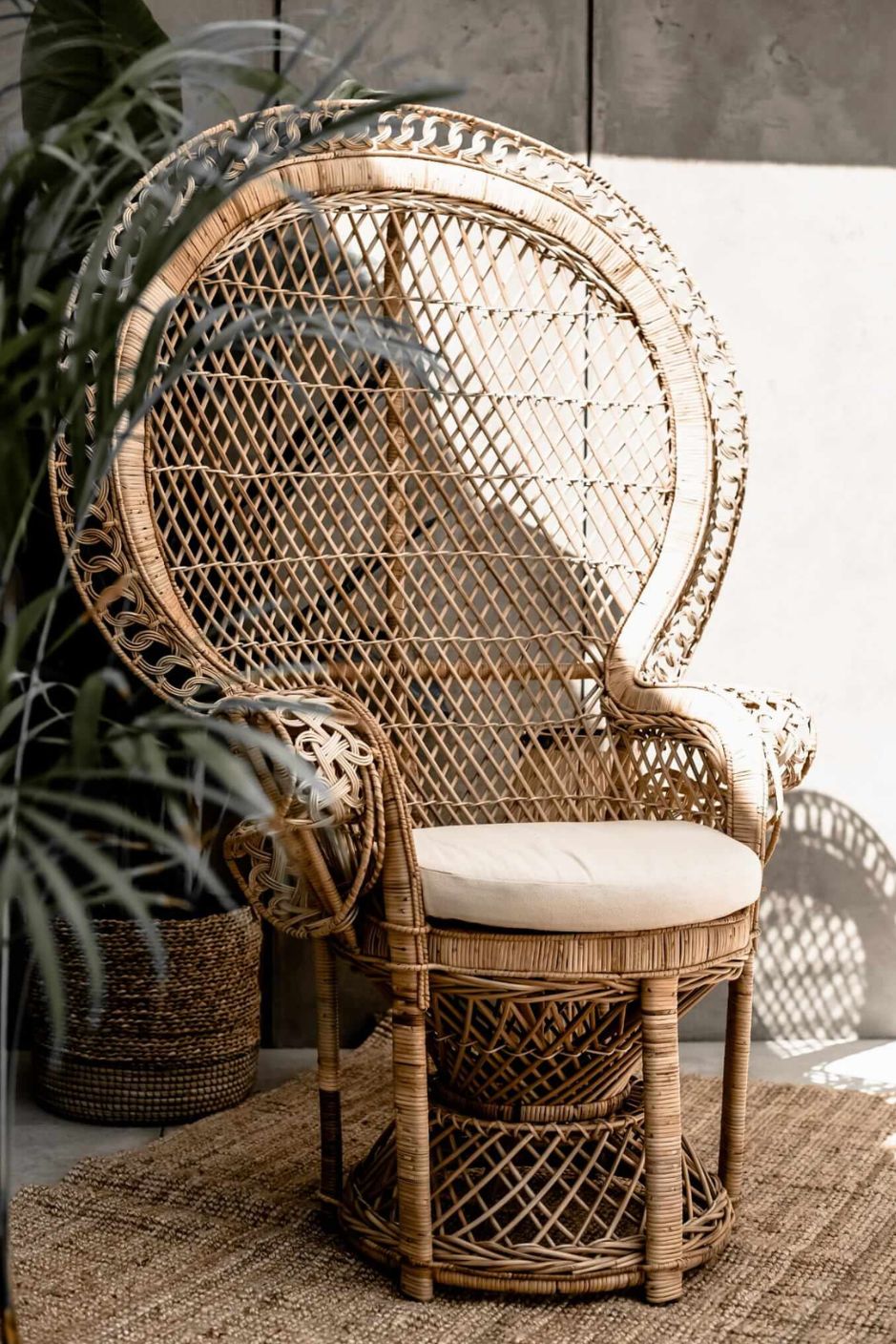 Peacock rattan chair with high back and cream cushion, handcrafted from natural rattan, perfect oversized boho accent for indoor or covered outdoor spaces