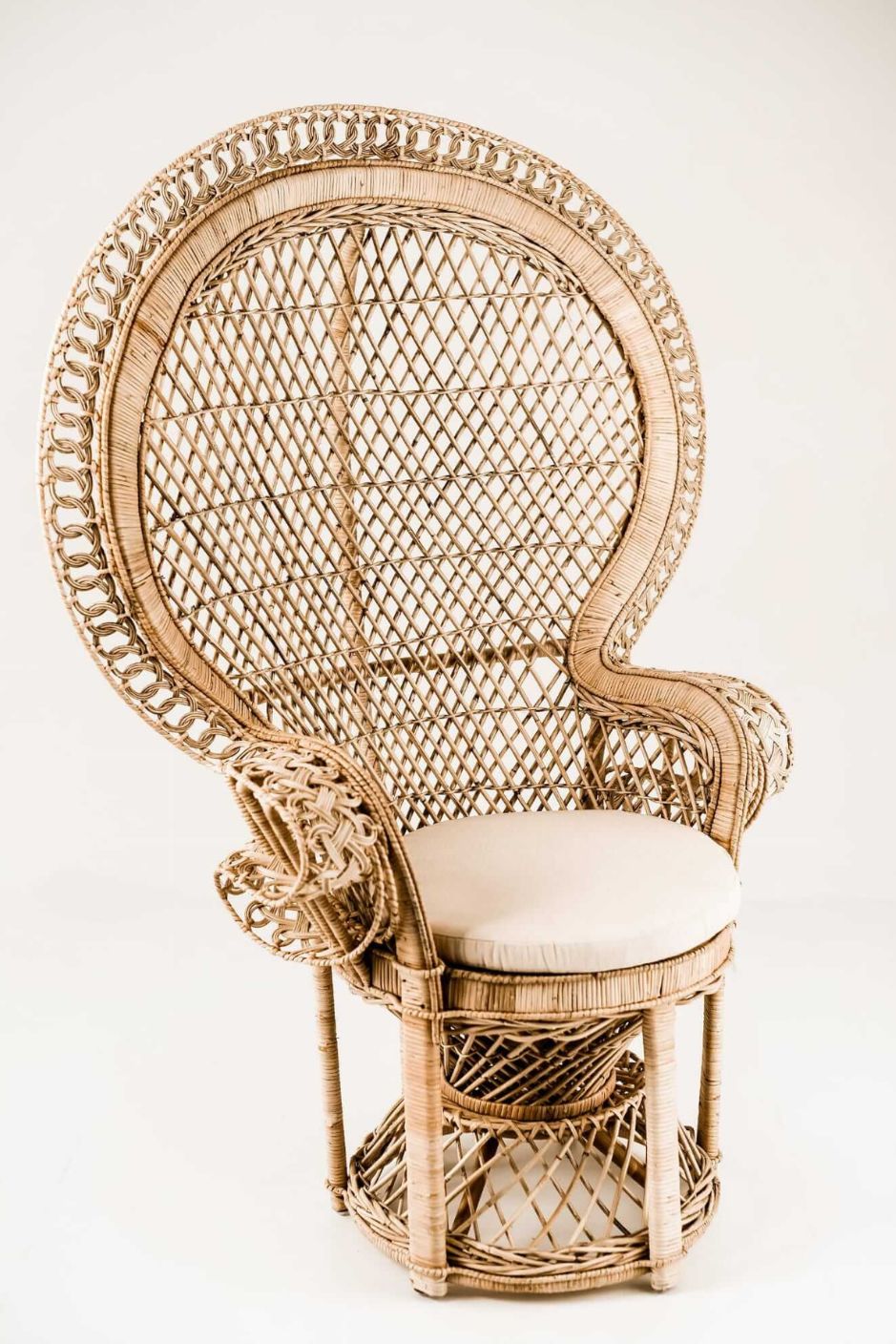 Peacock rattan chair with high back and cream cushion, handcrafted from natural rattan, perfect oversized boho accent for indoor or covered outdoor spaces