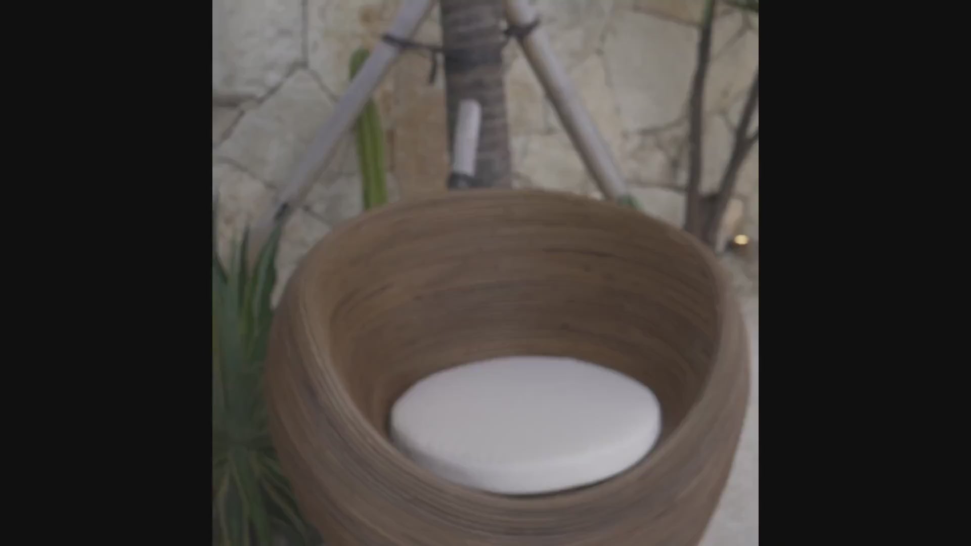 Handmade rattan armchair in dark brown with boho style, perfect for cozy living spaces