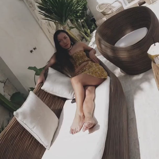 Handmade brown round rattan sofa Tegal with ecru cushions, designed for eco-friendly outdoor living on patios and terraces