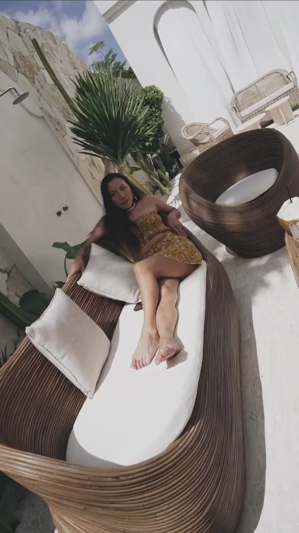 Handmade brown round rattan sofa Tegal with ecru cushions, designed for eco-friendly outdoor living on patios and terraces