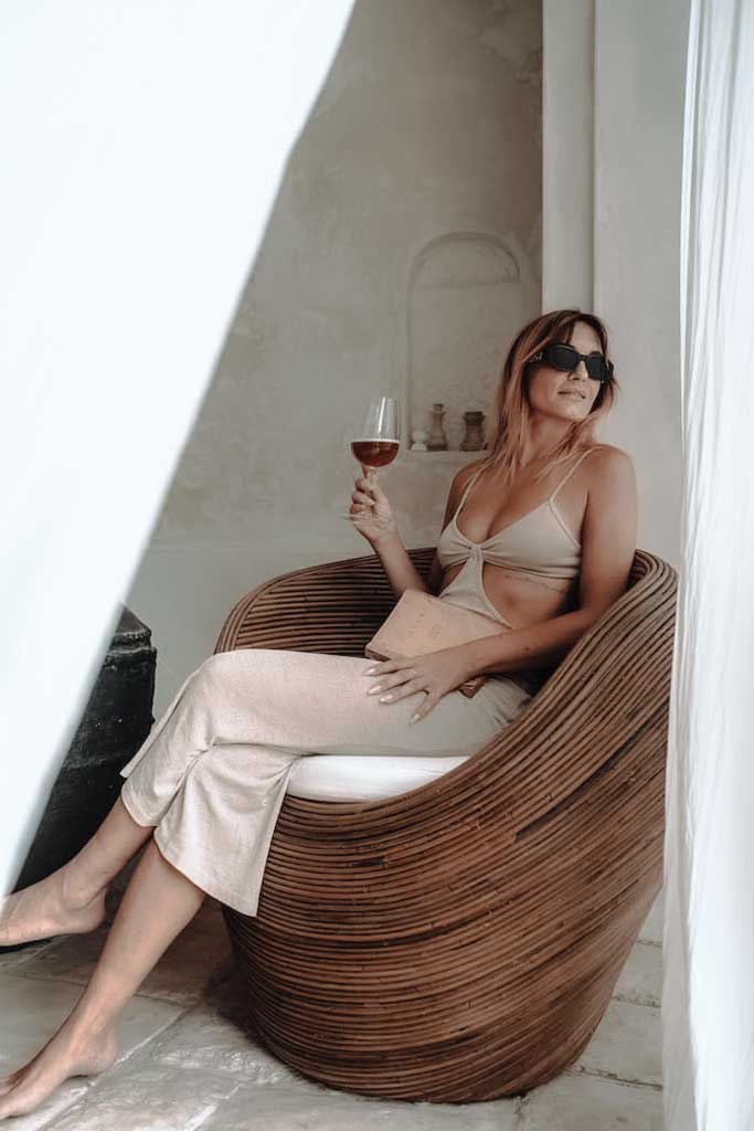 Handmade rattan armchair in dark brown with boho style, perfect for cozy living spaces