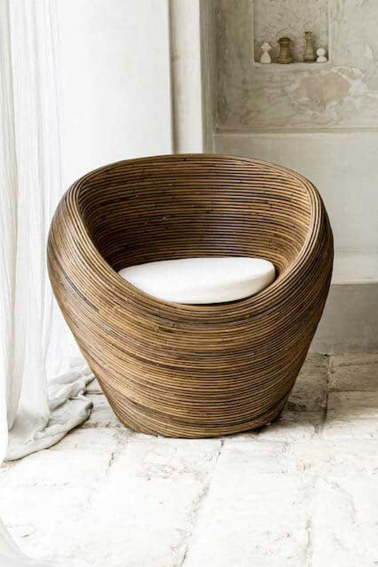 Handmade rattan armchair in dark brown with boho style, perfect for cozy living spaces