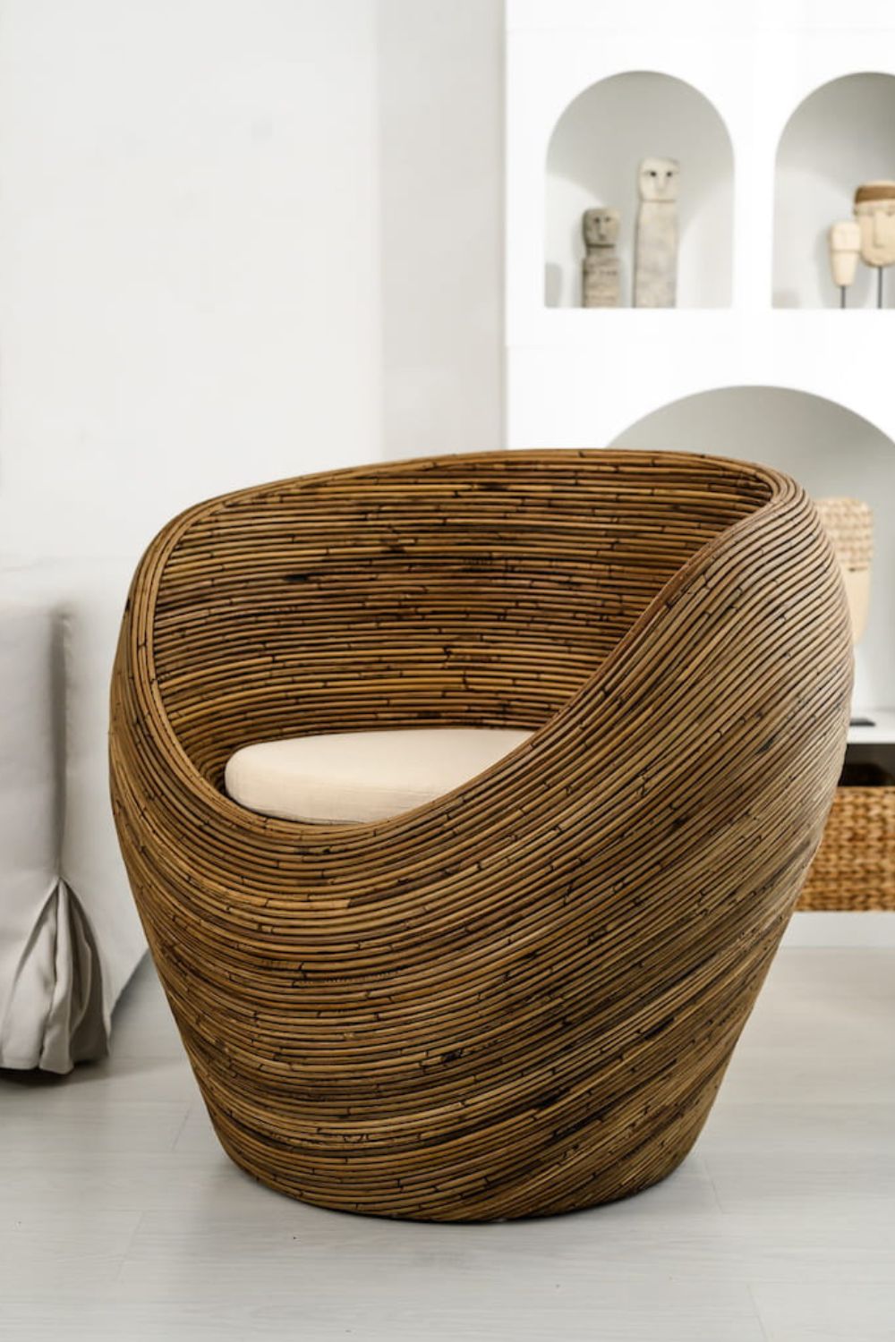 Handmade rattan armchair in dark brown with boho style, perfect for cozy living spaces