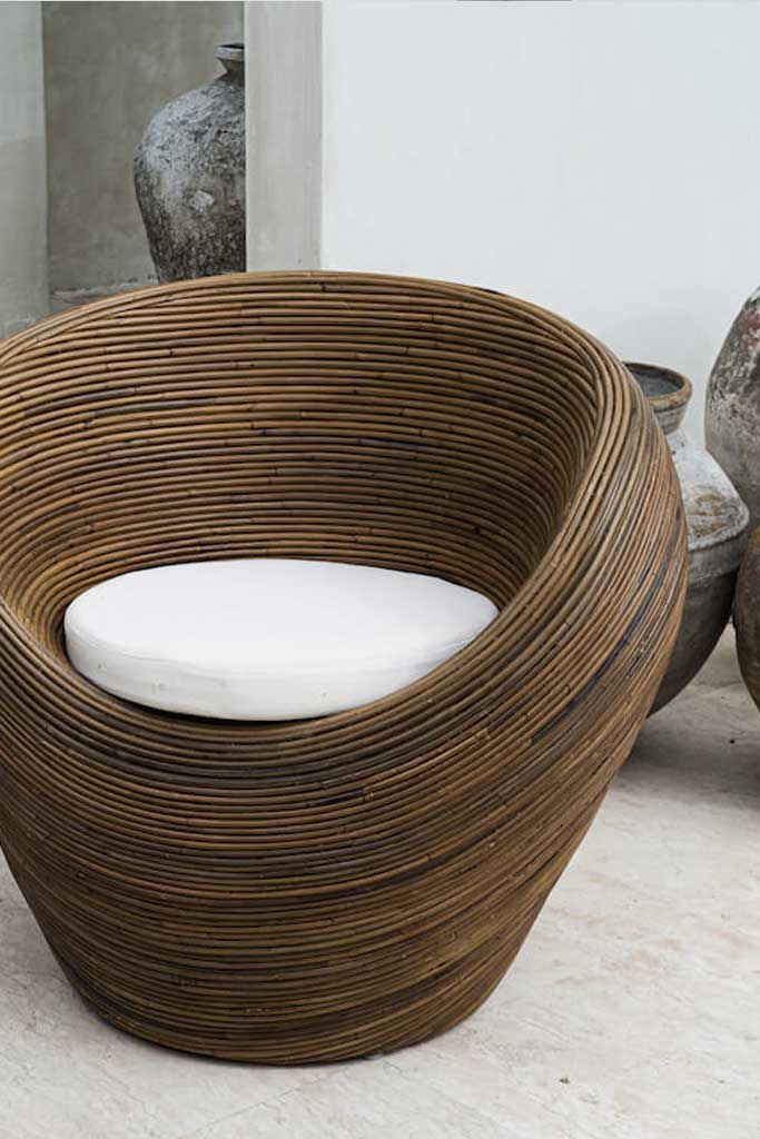 Handmade rattan armchair in dark brown with boho style, perfect for cozy living spaces