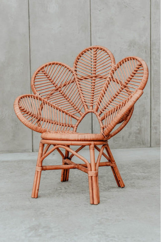 Rattan Monna Flower Chair featuring a handcrafted petal-shaped backrest and natural rattan weave, offering elegant bohemian style for indoor or outdoor spaces