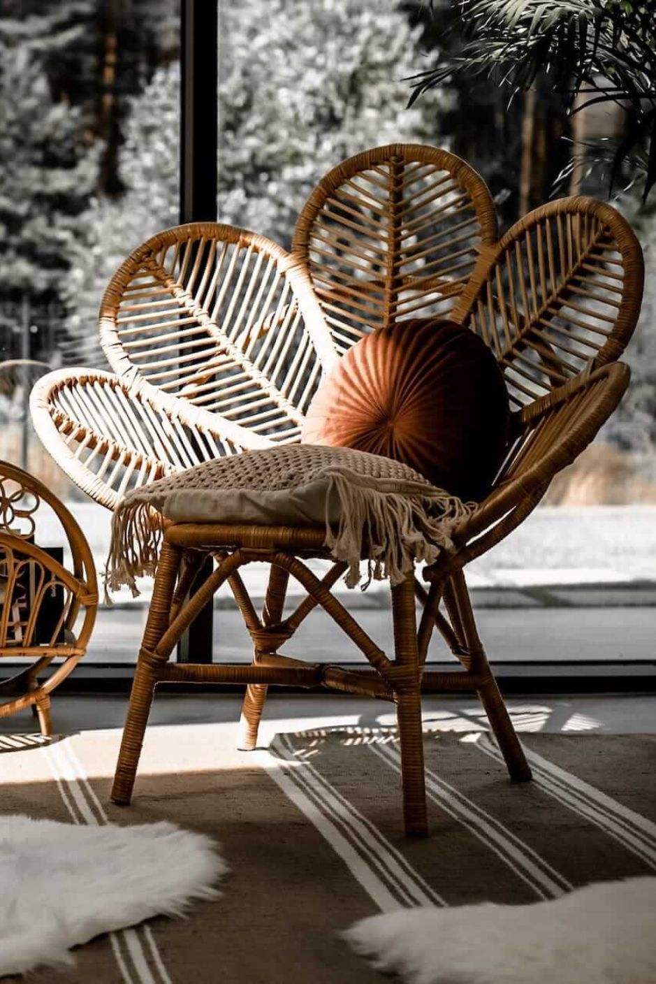 Rattan Monna Flower Chair featuring a handcrafted petal-shaped backrest and natural rattan weave, offering elegant bohemian style for indoor or outdoor spaces