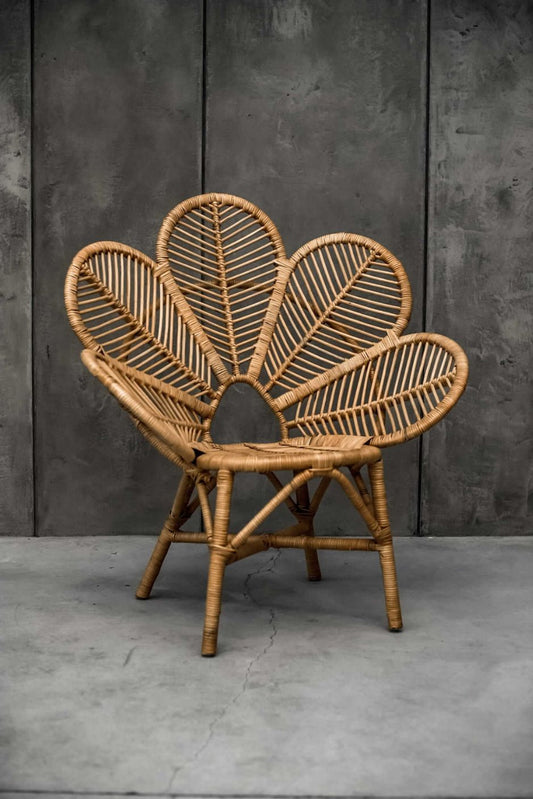 Rattan Monna Flower Chair featuring a handcrafted petal-shaped backrest and natural rattan weave, offering elegant bohemian style for indoor or outdoor spaces