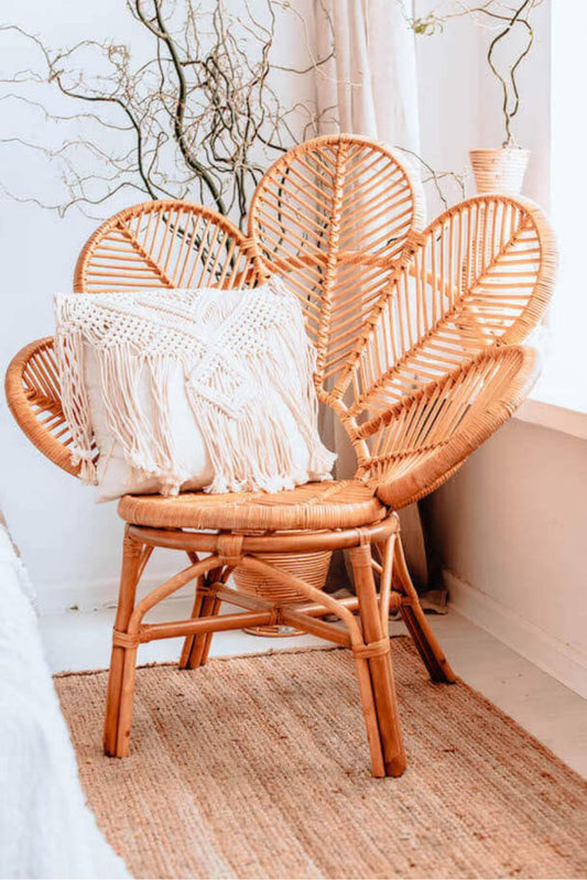 Rattan Monna Flower Chair featuring a handcrafted petal-shaped backrest and natural rattan weave, offering elegant bohemian style for indoor or outdoor spaces