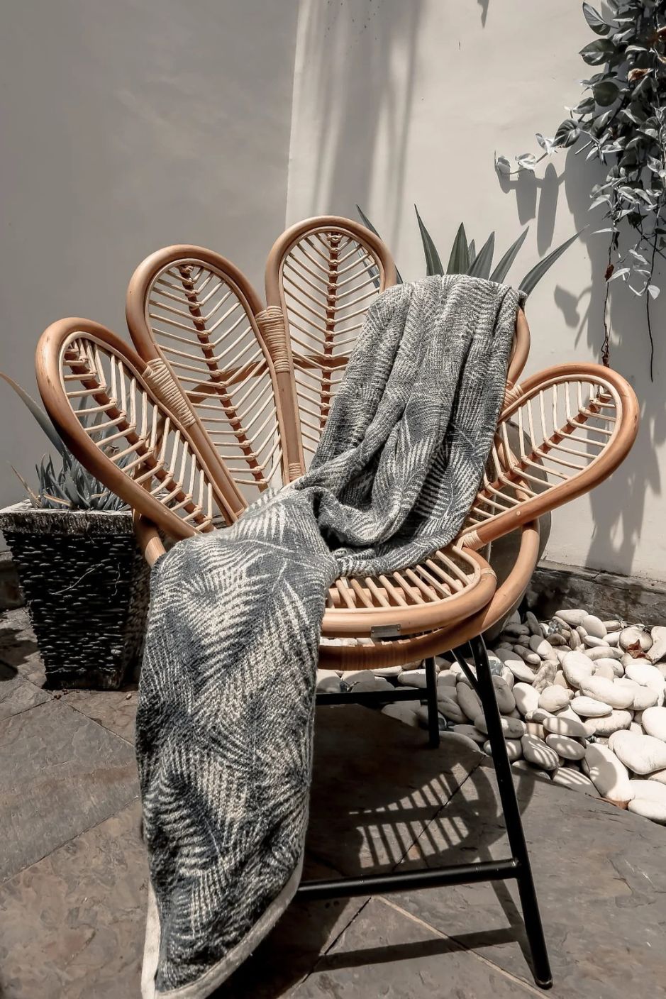 Rattan Sia Flower Chair in natural finish - handcrafted bohemian furniture with a petal-shaped backrest and woven rattan design, ideal for living rooms, bedrooms, or outdoor spaces