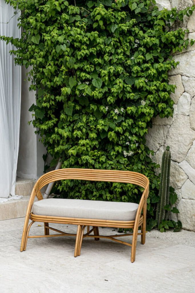 Handcrafted Sali sofa made from natural rattan with elegant flowing design and neutral tones, showcasing artisanal craftsmanship and timeless style